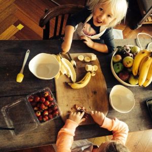 Cutting fruit to top our own pancakes while talking about how food has changed over the years since it was first invented Ancient Greece.